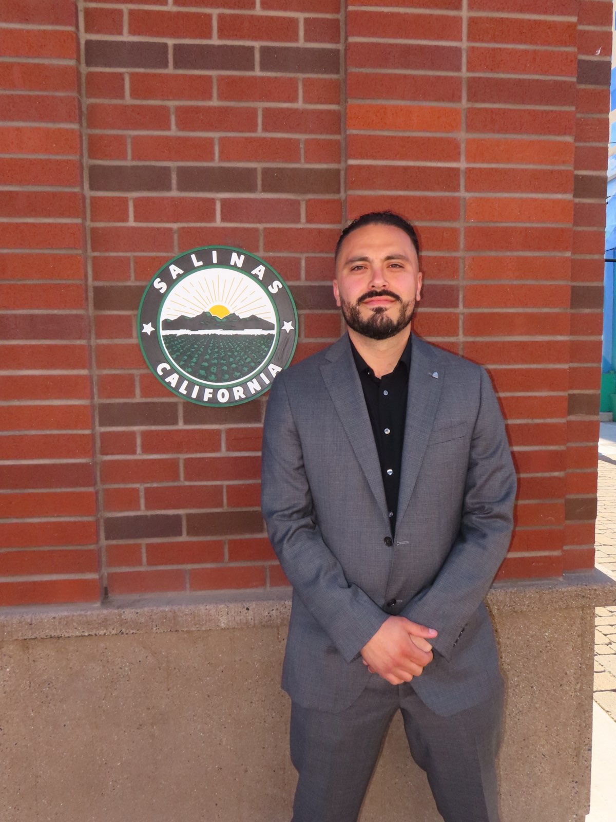Ignacio Fregoso standing next to the Salinas logo